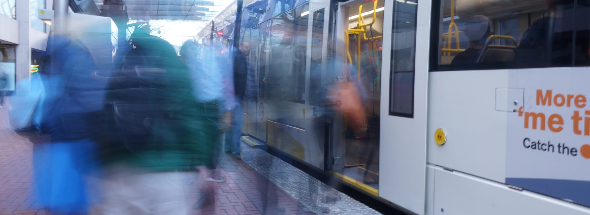 Blurry photo of people getting on light rail