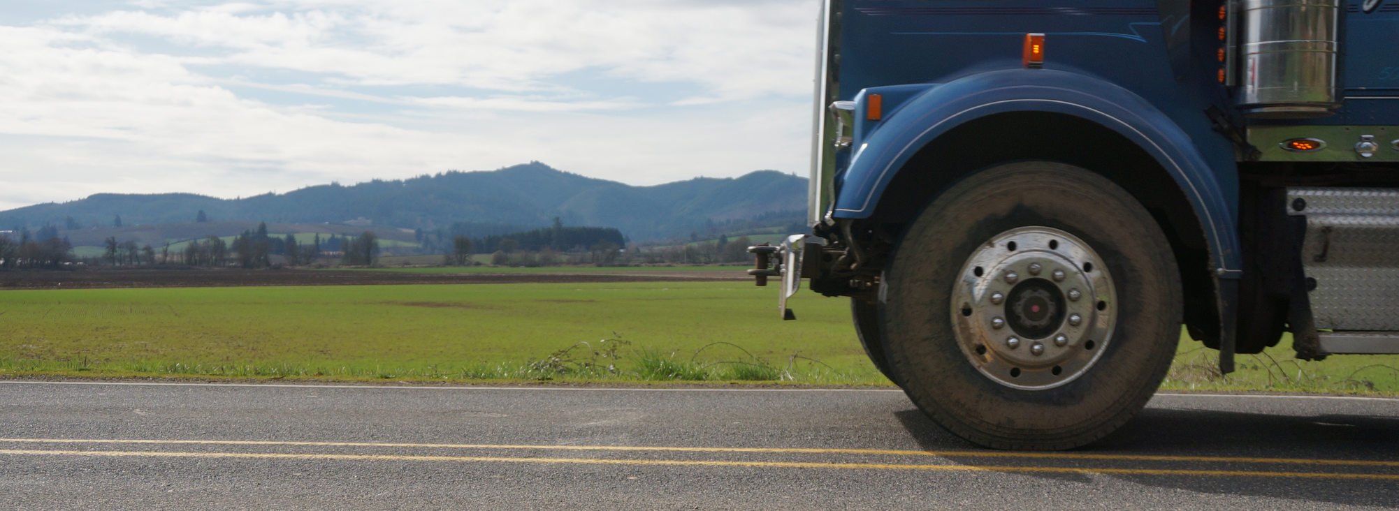 Wide shot of a freight truck wheel