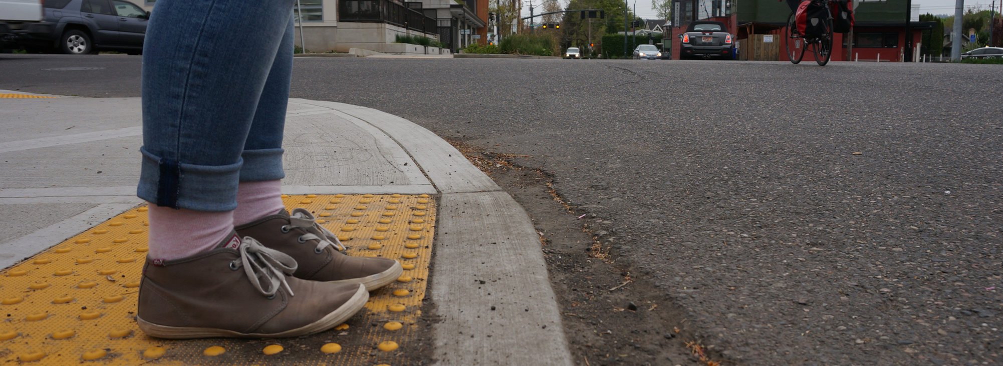 Feet waiting to cross a street