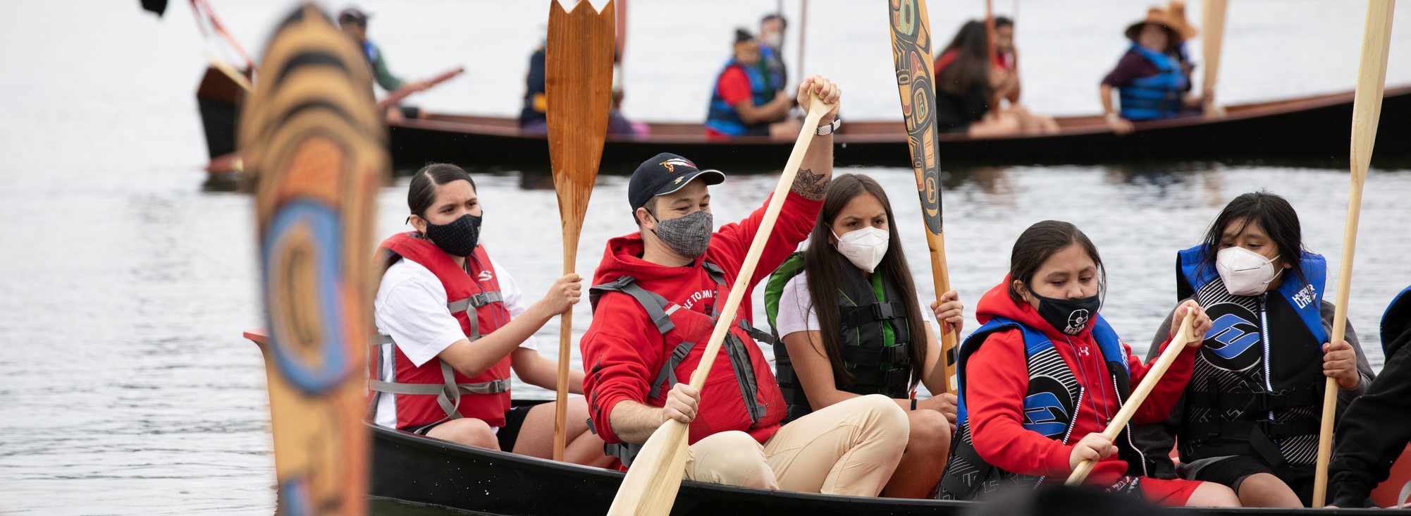 Portland All Nations Canoe Family rowing in a canoe together in the Columbia River