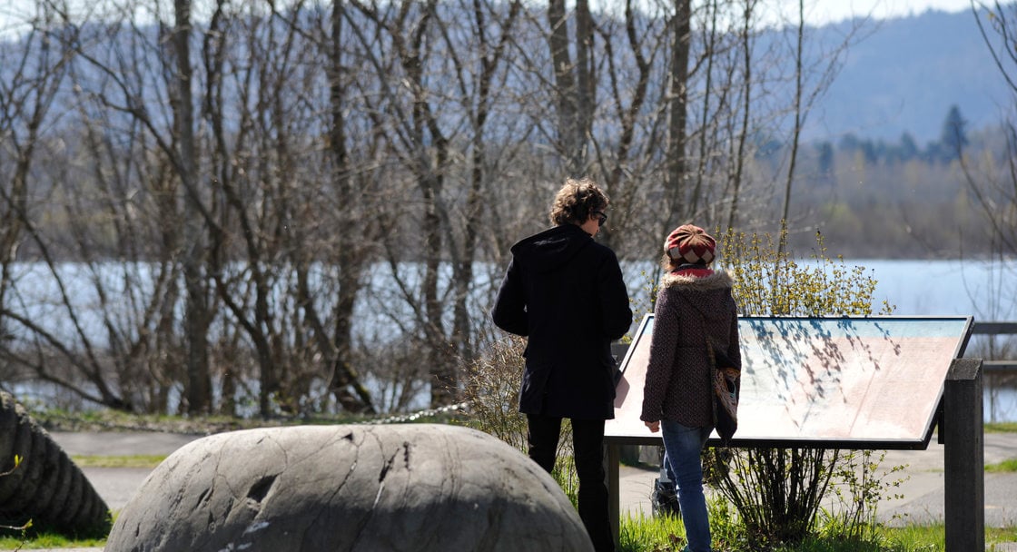 photo of father and daughter reading an interpretive sign