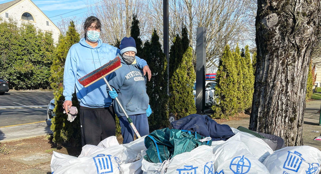 An image of volunteers in front bags of trash they collected.