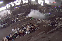 Smoke billows from the trash pit at Metro South transfer station