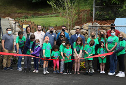 Image of children and adults cutting a ribbon to open DC Latourette Park