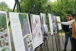 A series of large renderings on easels depicting construction images and maps for the Viewfinder apartments in Tigard